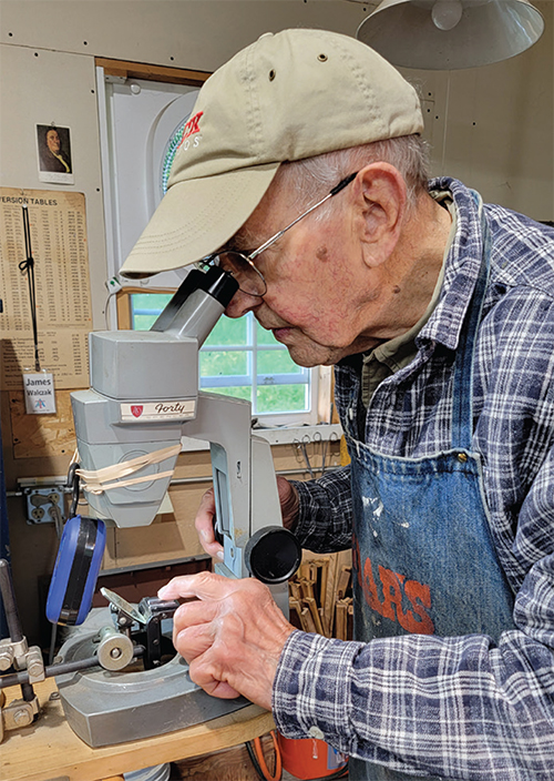 Photograph of Jim Walczak at the microscope in June 2024