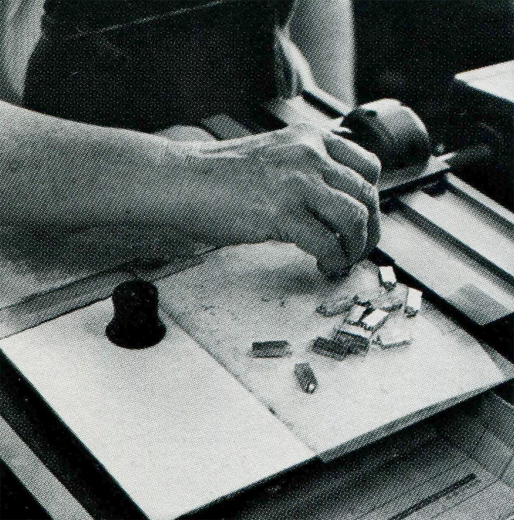 Operator hands trimming the underside of kerned characters