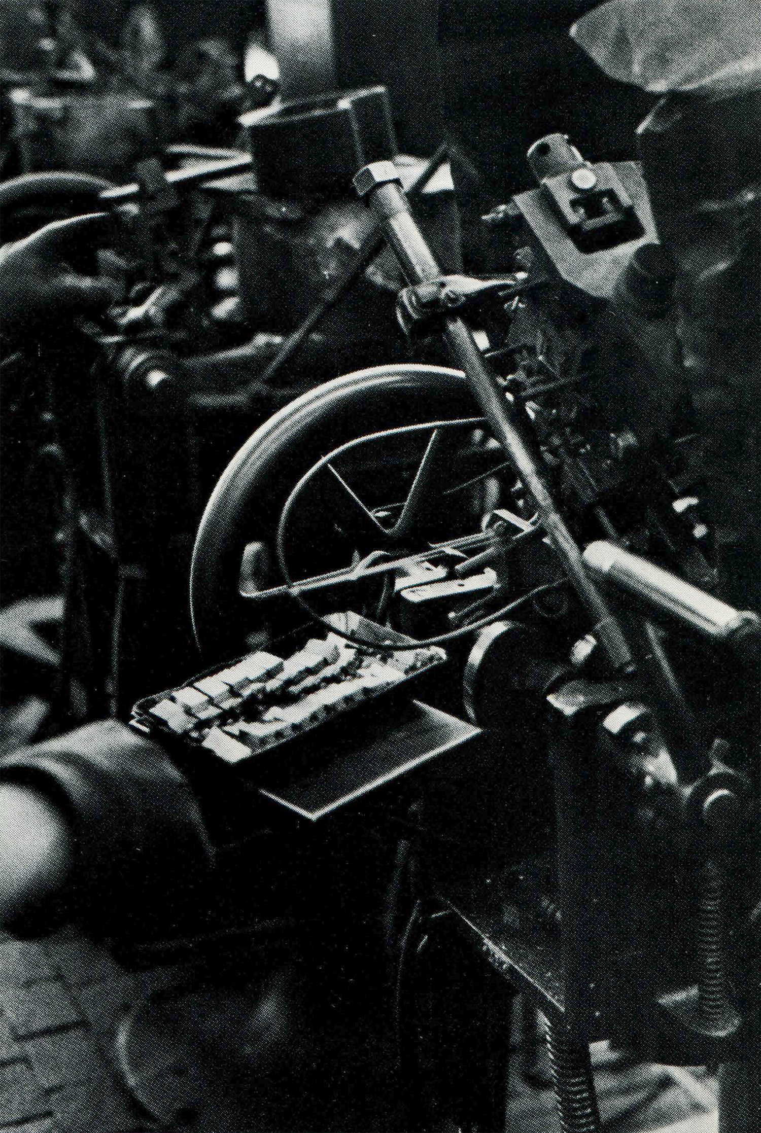 hand removing newly cast letters from machine